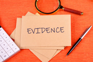 Evidence cards on an orange background with pen and spy glass