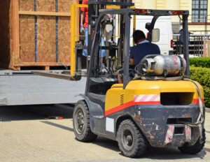 A yellow forklift operates in a warehouse.