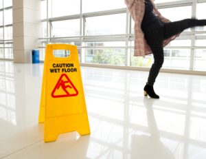 PERSON SLIPPING ON A WET FLOOR SURFACE