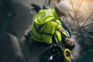 A construction worker lays on the floor after a scaffolding accident 