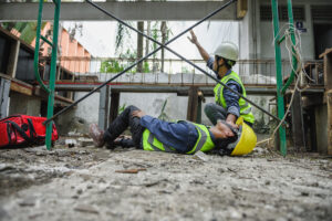 Two construction workers are on the ground after a scaffolding accident 
