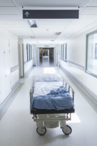 A hospital bed in a corridor to indicate the loss of a patient