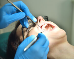 A dentist is checking their patients teeth