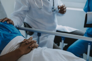 A patient lies in a hospital bed after negligently performed surgery.
