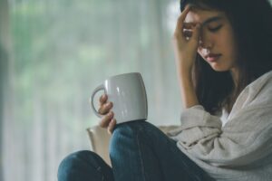 PTSD sufferer drinking tea to comfort herself