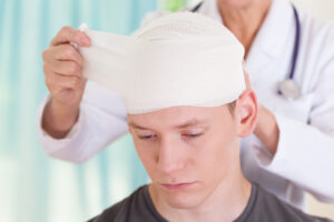 A person with a bandaged head wondering how much compensation for concussion they might be able to claim for.