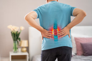 A person experiences nerve damage in their lower back.