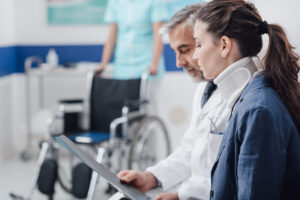 An injured woman goes over medical notes with a doctor.
