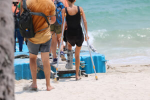 An injured passenger boards a boat.