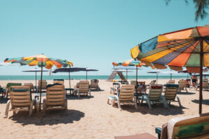 An image shows sun loungers on a beach.