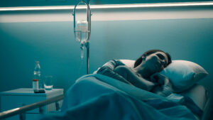 Woman in a hospital bed after suffering from NHS negligence.