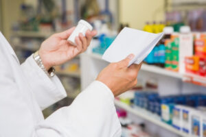 Pharmacist checks the medication dispensed to make sure it isn't the wrong prescription
