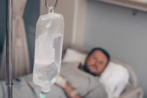 A person lying in a hospital bed after experiencing clinical negligence