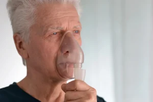 A man wears an oxygen mask after experiencing health problems from mould growth