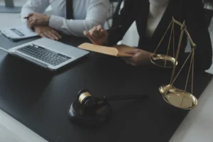 Two personal injury solicitors advise their client about a no win no fee contract 