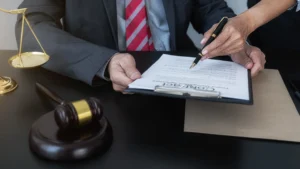 A medical negligence solicitor sat at their desk discussing how much compensation for surgical errors a client might get